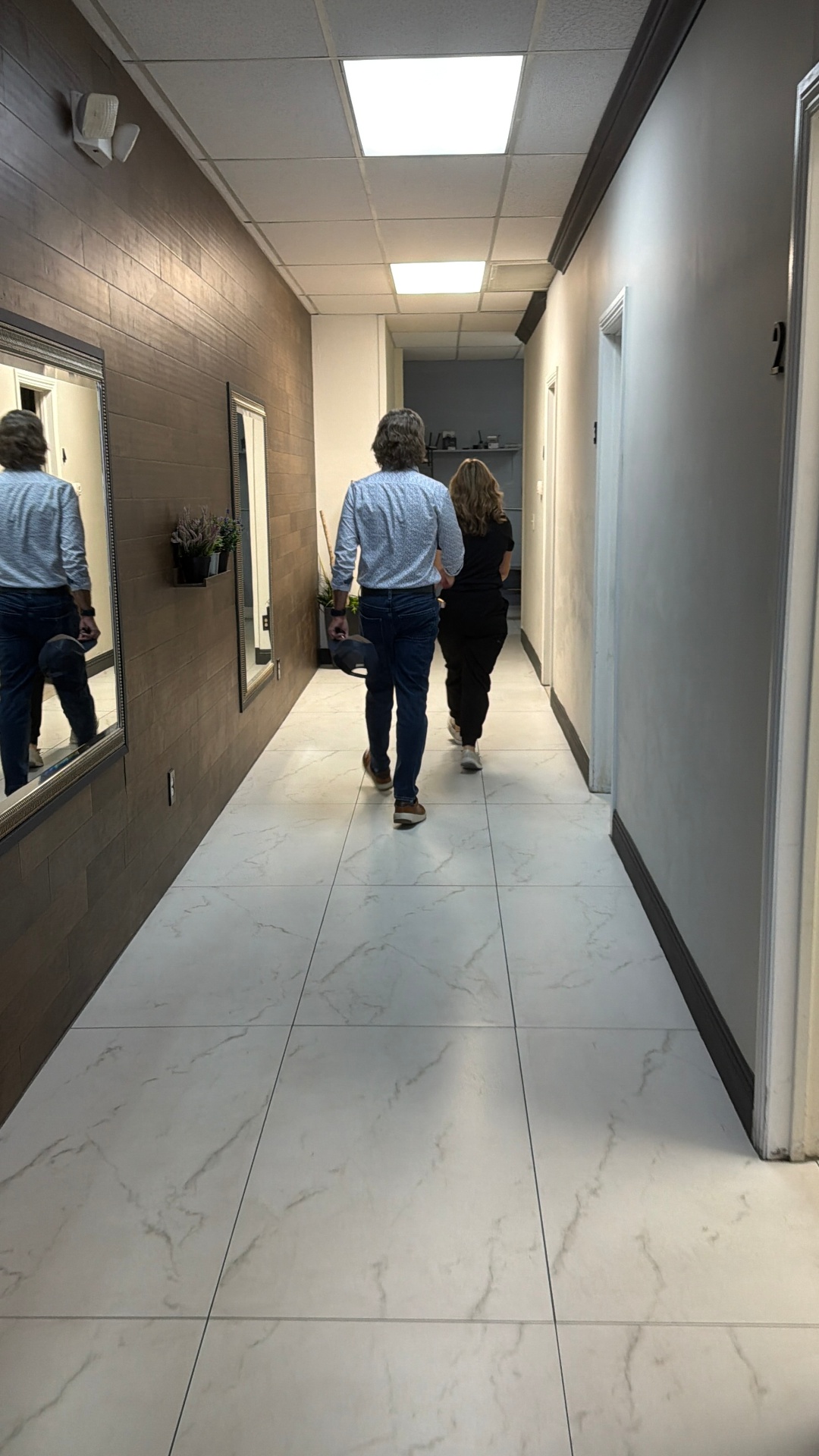 A guest being welcomed through the bright hallway inside Jumeaux Las Vegas