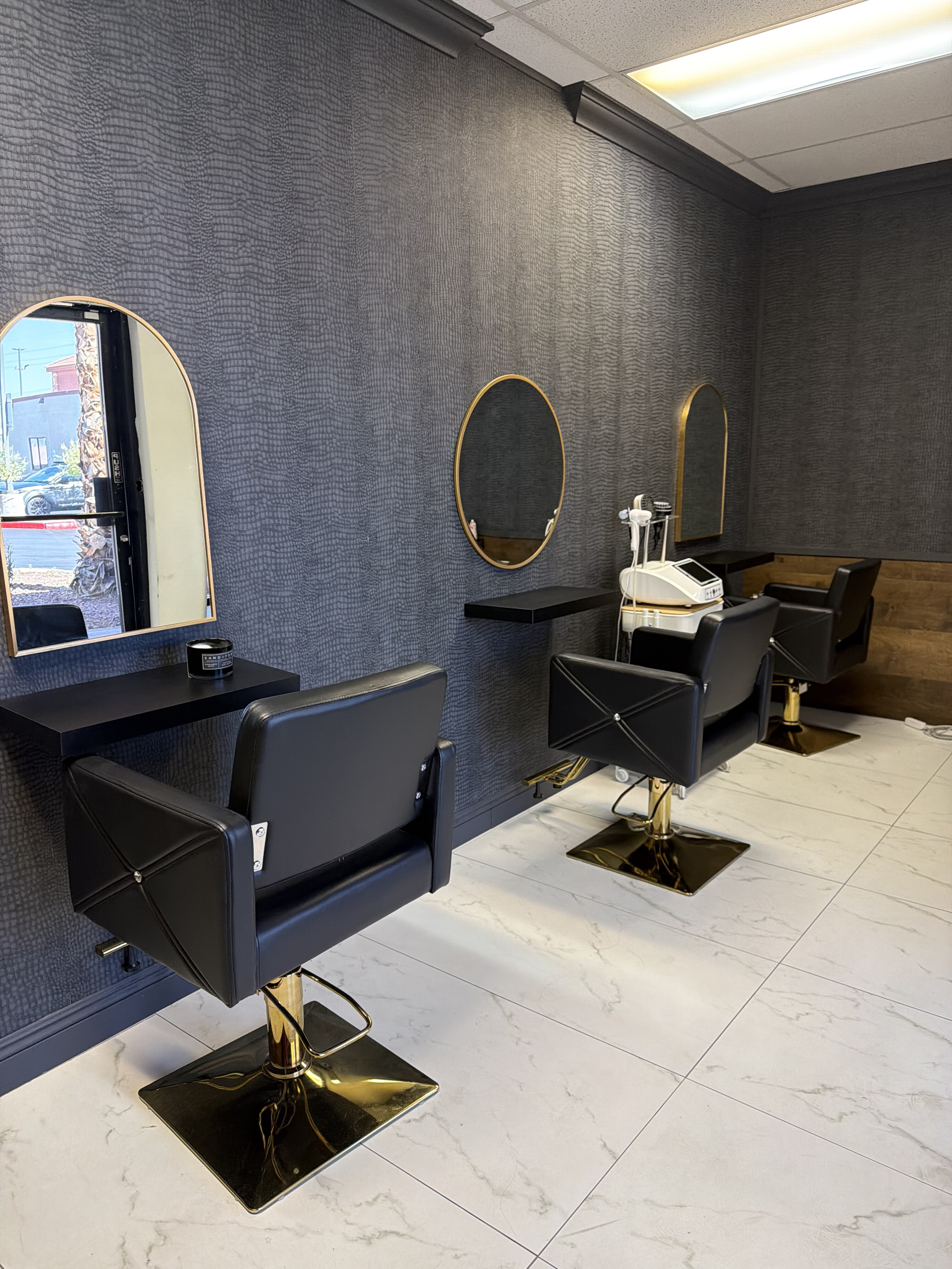 Black and gold styling stations inside the Jumeaux Las Vegas facility